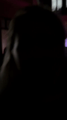 Excited person captured on video in purple-lit Paris setting