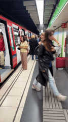 Commuters exit subway train at Barcelona metro station