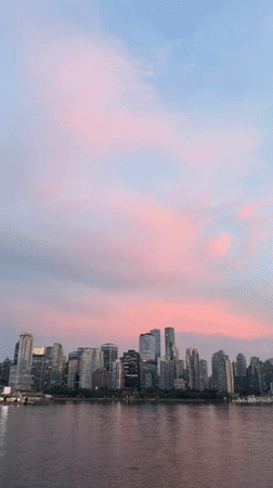 Vancouver skyline glows under a pink and purple twilight sky
