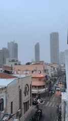 Overcast day documented on Tel Aviv street with mixed architecture