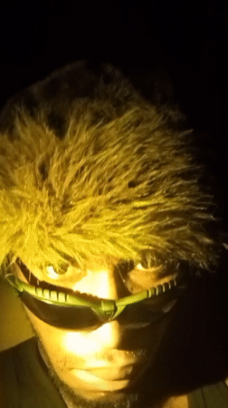 Late-night style shoot in Lokoja, cycling through hats and sunglasses