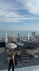 Summer afternoon leisure documented along Sochi-Sirius coastal promenade