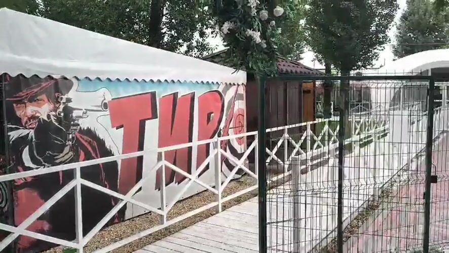 Military-themed fairground with carnival booths and VR pods, Mikhaylovka