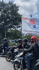 Labor Day motorcycle rally proceeds through Tebel, Indonesia streets