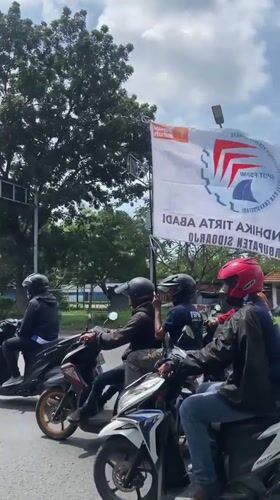Labor Day motorcycle rally proceeds through Tebel, Indonesia streets