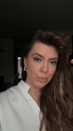 Woman takes selfie with playful Shih Tzu in Tbilisi