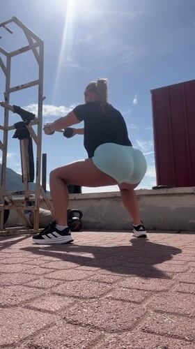 Woman exercises with dumbbells on Montenegro rooftop workout area