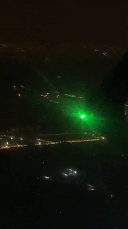 Passenger documents nighttime flight views over Beijing, laser incident