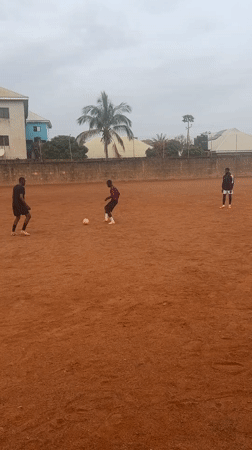 Soccer players practice on dirt field in Nigeria