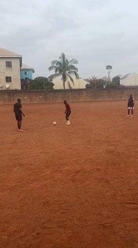 Soccer players practice on dirt field in Nigeria