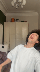 Young man dances, sings energetically in Moscow bedroom