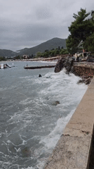 Busy beach day in Budva under overcast summer skies