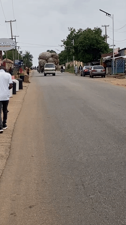 Children play with tires, vendor works streets in Bukuru