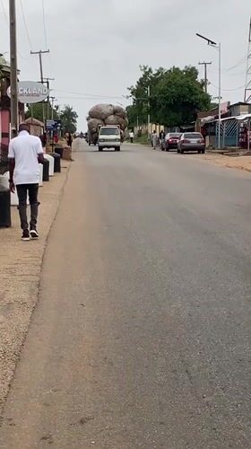 Children play with tires, vendor works streets in Bukuru