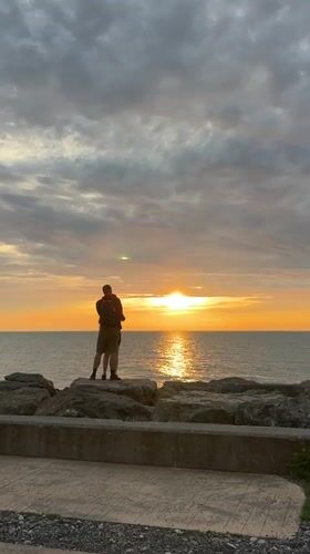 Couple embraces on Batumi breakwater at sunset