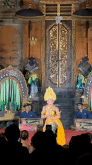 Traditional Balinese dancer performs in temple courtyard, Ubud District