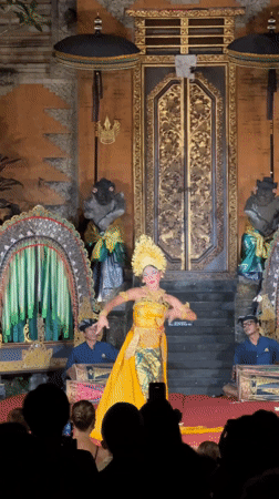 Traditional Balinese dancer performs in temple courtyard, Ubud District