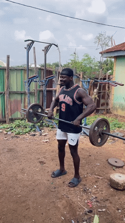 Man conducts outdoor weightlifting session in Akwanga, Nigeria