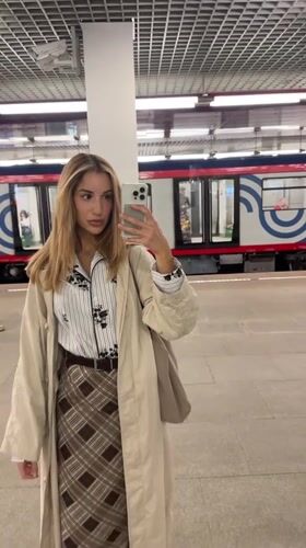 Mirror selfie on a Moscow metro platform, trench coat look