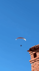 Paramotors and a boat share a clear Croatian afternoon
