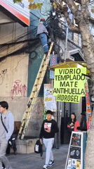 Utility worker repairs building wires in La Paz