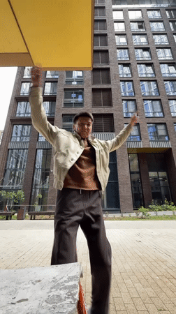 Dancing and posing between modern brick towers in Moscow