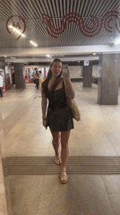 Woman records mirror selfie in Moscow public space