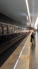 Woman waits for train on Moscow subway platform