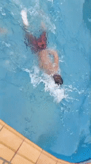 Adult and child share casual swimming pool time