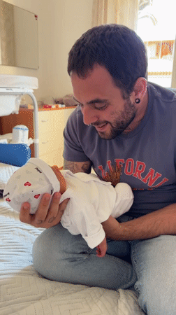 New father enjoys afternoon stroll with baby in Aprilia