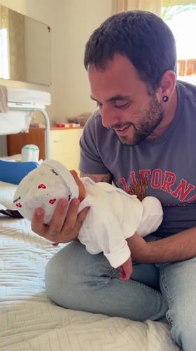 New father enjoys afternoon stroll with baby in Aprilia
