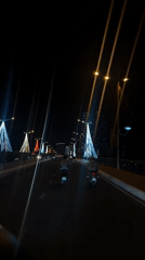 Night traffic flows across illuminated bridge in Nha Trang