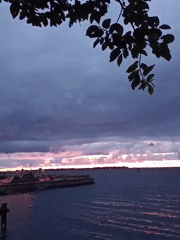 Stormy sunset over Tallinn's waterfront, pier in frame