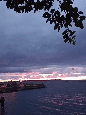 Stormy sunset over Tallinn's waterfront, pier in frame