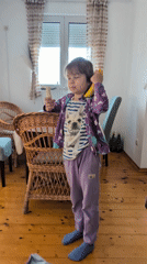 Child uses banana as pretend telephone in Montenegro playroom