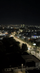 Nighttime aerial view captures illuminated Izhevsk cityscape with sparse traffic