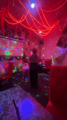 Karaoke night at a neon-lit bar in Chaikovsky, Russia