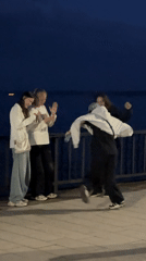 Young people dance, socialize at Chaikovsky waterfront during sunset