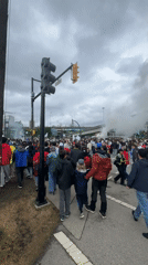 Organized street march moves through downtown Vancouver with flags and smoke
