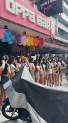 Daytime street activity recorded outside Pattaya bars, pedestrians walking