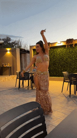 Belly dancer performs at outdoor restaurant in Noto, Italy