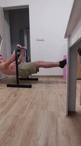 Man performs parallel bar workout during sunset in Burgas
