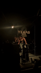Dancers perform synchronized routine in dimly lit Puebla venue