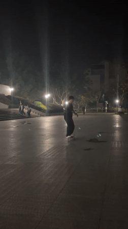 Young man skateboarding at night in Jiangjin, China