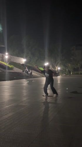 Young man skateboarding at night in Jiangjin, China