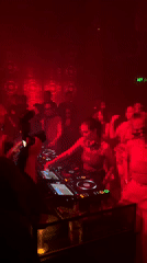 DJ set at a red-lit Bali nightclub, Arien Catherine performing