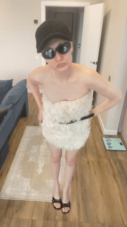 Person in white dress documented indoors in Подшивалово