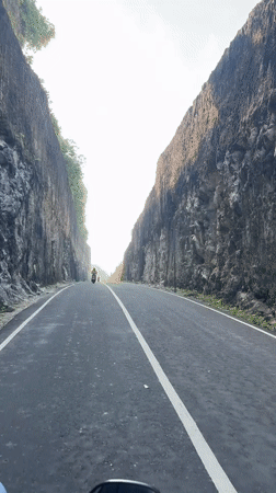 Late-night motorcycle ride filmed along Indonesia clifftop coastal road