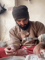 Afghan artisan polishes gemstones in traditional Kandahar workshop