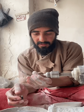 Afghan artisan polishes gemstones in traditional Kandahar workshop